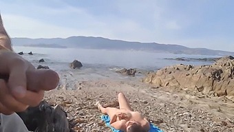 Voyeur Captures A Man Exposing Himself To A Nudist Milf Who Performs Oral Sex On The Beach